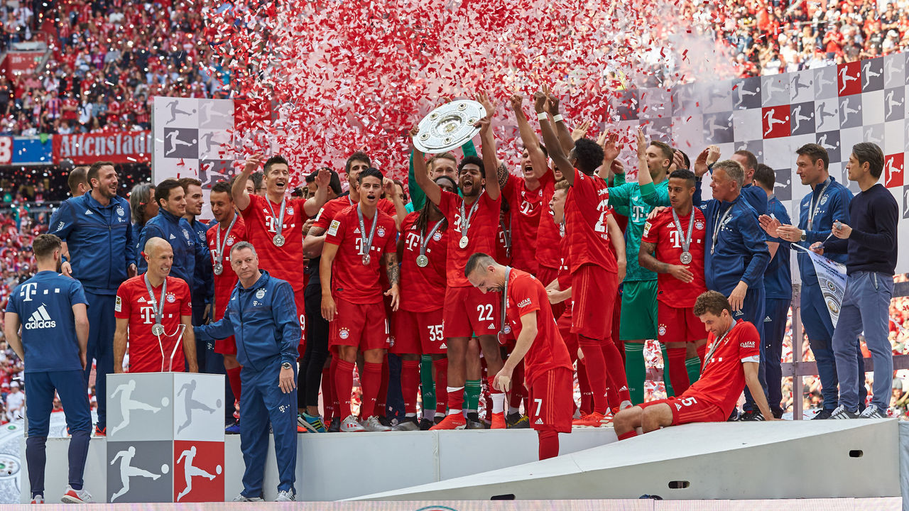 MUNICH, GERMANY - MAY 18: Players of FC Bayern Muenchen celebrate with the championship trophy after the Bundesliga match between FC Bayern Muenchen and Eintracht Frankfurt at Allianz Arena on May 18, 2019 in Munich, Germany.