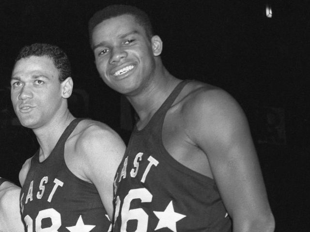 (Original Caption) To Face West All-Stars. New York: Here are the coach and members of the East All-Star team which will meet a team of West All-Stars at Madison Square Garden Saturday evening. Coach is Ken Leoffler of La Salle. The boys (LTR) are: Bill Evans (Kentucky), Buzzy Wilkinson (Virginia), Ed Fleming (Niagara), Dick Hemric (Wake Forest), Jesse Arnelle (Penn State), Ed Conlin (Fordham), Tom Gola (La Salle), Walt Devlin (George Washington), Dick Ricketts (Duquesne) and Maurice Stokes (St. Francis, P.A.).
