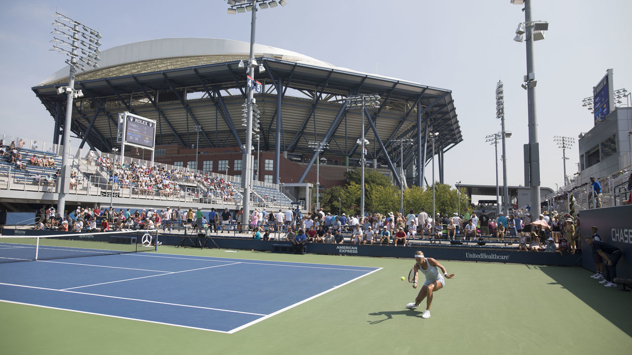2018 US Open Tennis Tournament- Day Two. A general view of the outside courts with Arthur Ashe Stadium providing the backdrop as Anna Karolina Schmiedlova of Slovakia takes on Yafan Wang of China on court four in the Women's Singles round one match at the 2018 US Open Tennis Tournament at the USTA Billie Jean King National Tennis Center on August 28th, 2018 in Flushing, Queens, New York City.