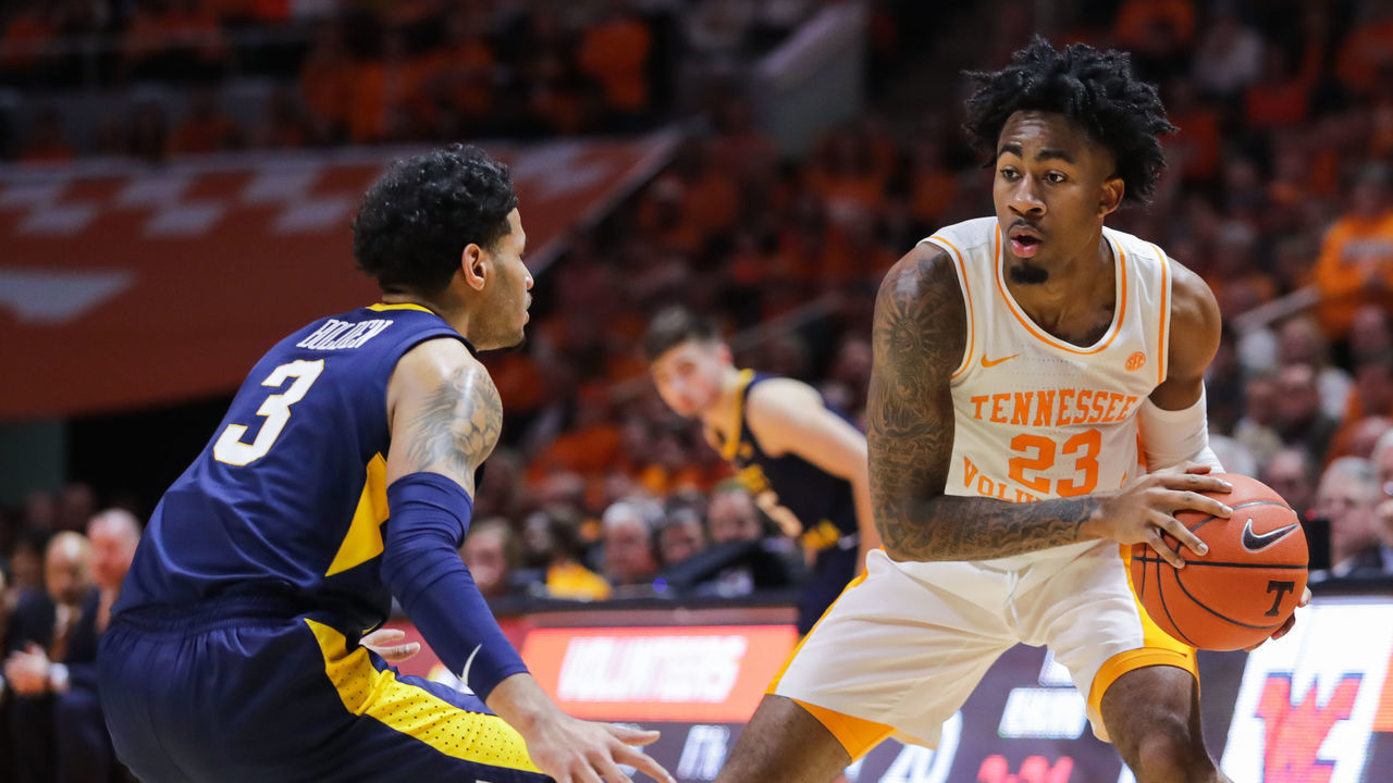 KNOXVILLE, TN - JANUARY 26: Jordan Bowden #23 of the Tennessee Volunteers looks to pass the ball with James Bolden #3 of the West Virginia Mountaineers defending during their game at Thompson-Boling Arena on January 26, 2019 in Knoxville, Tennessee.
