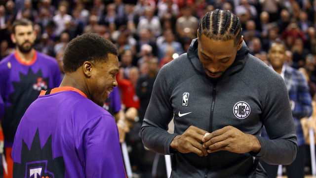 TORONTO, ON - DECEMBER 11: Kyle Lowry (L) of the Toronto Raptors presents Kawhi Leonard (R) of the Los Angeles Clippers with his Championship Ring prior to an NBA game at Scotiabank Arena on December 11, 2019 in Toronto, Canada.