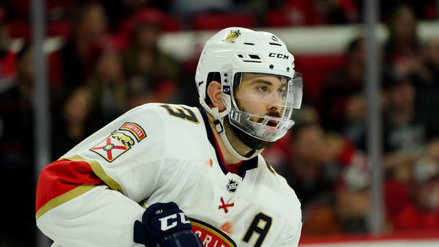 RALEIGH, NC - NOVEMBER 23: Keith Yandle #3 of the Florida Panthers wears a full face shield after being hit in the mouth by a puck, loosing 9 teeth in the first period during an NHL game against the Carolina Hurricanes on November 23, 2019 at PNC Arena in Raleigh, North Carolina.