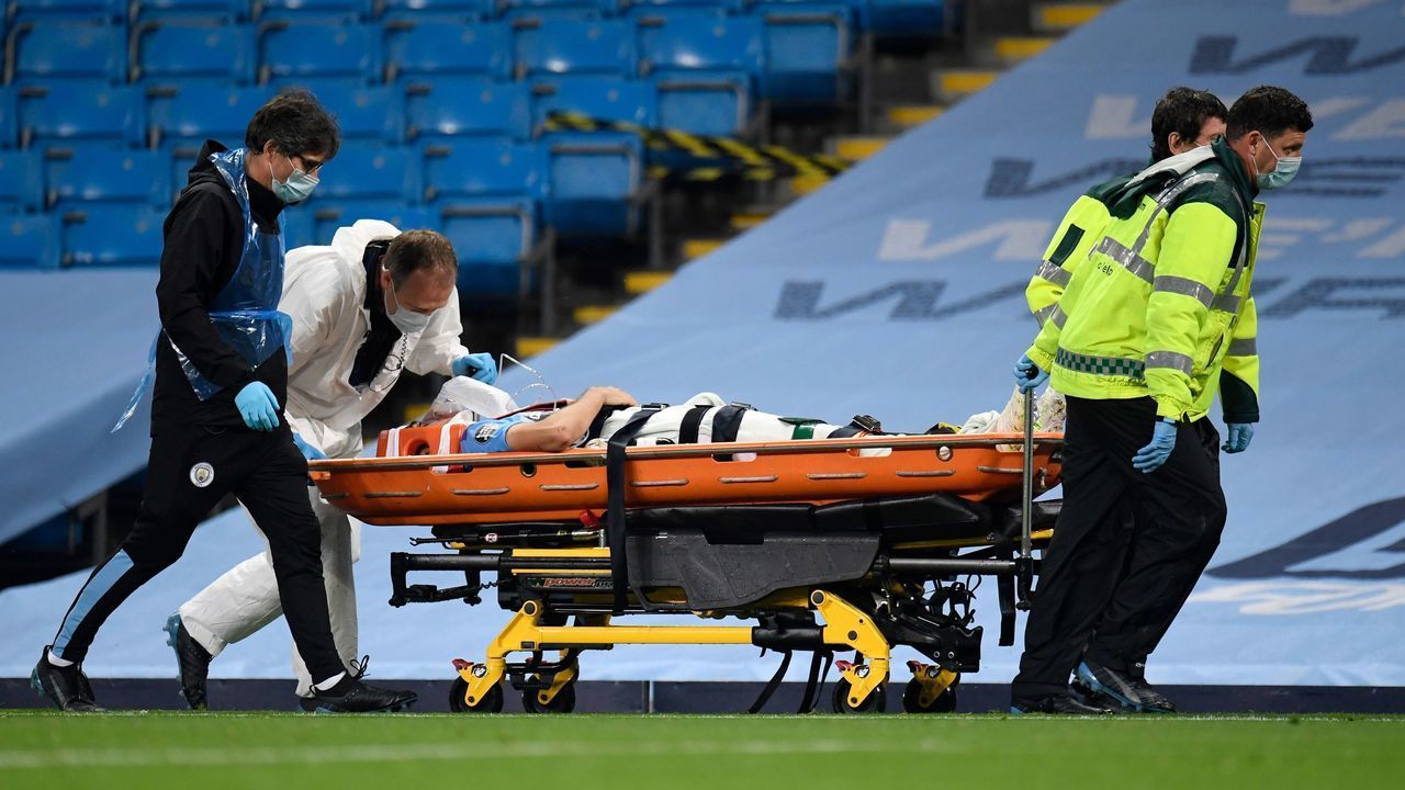 Manchester City's Spanish defender Eric Garcia is stretchered off the pitch after colliding with Manchester City's Brazilian goalkeeper Ederson during the English Premier League football match between Manchester City and Arsenal at the Etihad Stadium in Manchester, north west England, on June 17, 2020. - The Premier League makes its eagerly anticipated return today after 100 days in lockdown but behind closed doors due to coronavirus restrictions.