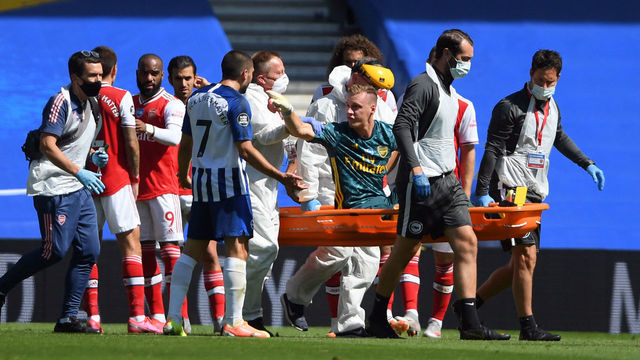 Arsenal's German goalkeeper Bernd Leno (on stretcher) remonstrates with Brighton's French striker Neal Maupay after the keeper was injured during the English Premier League football match between Brighton and Hove Albion and Arsenal at the American Express Community Stadium in Brighton, southern England on June 20, 2020.