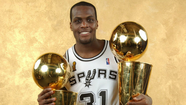 SAN ANTONIO - JUNE 15: Malik Rose #31 of the San Antonio Spurs poses with the Larry O'Brien trophy after defeating the New Jersey Nets in Game six of the 2003 NBA Finals at SBC Center on June 15, 2003 in San Antonio, Texas. The Spurs won 88-77 and defeated the Nets to win the NBA Championship. NOTE TO USER: User expressly acknowledges and agrees that, by downloading and/or using this Photograph, User is consenting to the terms and conditions of the Getty Images License Agreement Mandatory Copyright Notice: Copyright 2003 NBAE