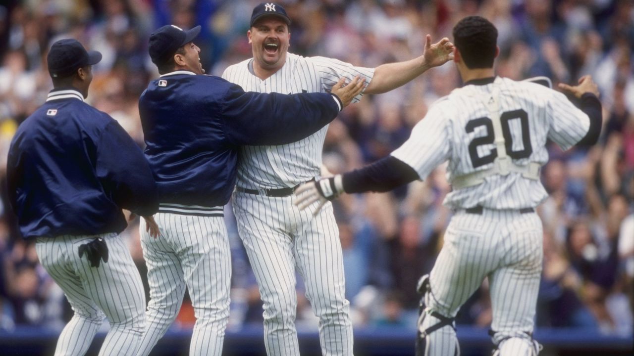 17 May 1998: David Wells #33 of the New York Yankees celebrates his perfect game against the Minnesota Twins with teammates Jorge Posada #20 and Luis Sojo #19 at Yankee Stadium in the Bronx, New York. The Yankees defeated the Twins 4-0.
