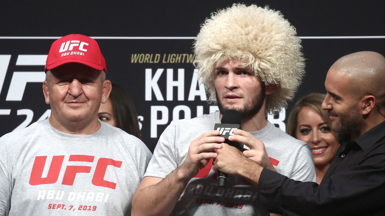 ABU DHABI, UNITED ARAB EMIRATES SEPTEMBER 6, 2019: UFC lightweight champion Khabib Nurmagomedov (C) and his father and coach Abdulmanap Nurmagomedov (L) at an official weigh-in ceremony ahead of his title unification bout against interim UFC lightweight champion Dustin Poirier at the UFC 242 mixed martial arts tournament. Valery Sharifulin/TASS