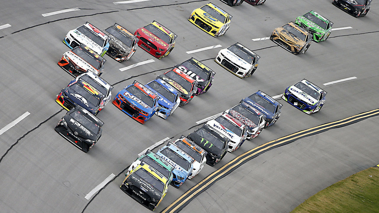 TALLADEGA, ALABAMA - JUNE 22: Ryan Blaney, driver of the #12 Menards/Sylvania Ford, and Denny Hamlin, driver of the #11 Drive for Change Toyota, lead a pack of cars during the NASCAR Cup Series GEICO 500 at Talladega Superspeedway on June 22, 2020 in Talladega, Alabama.