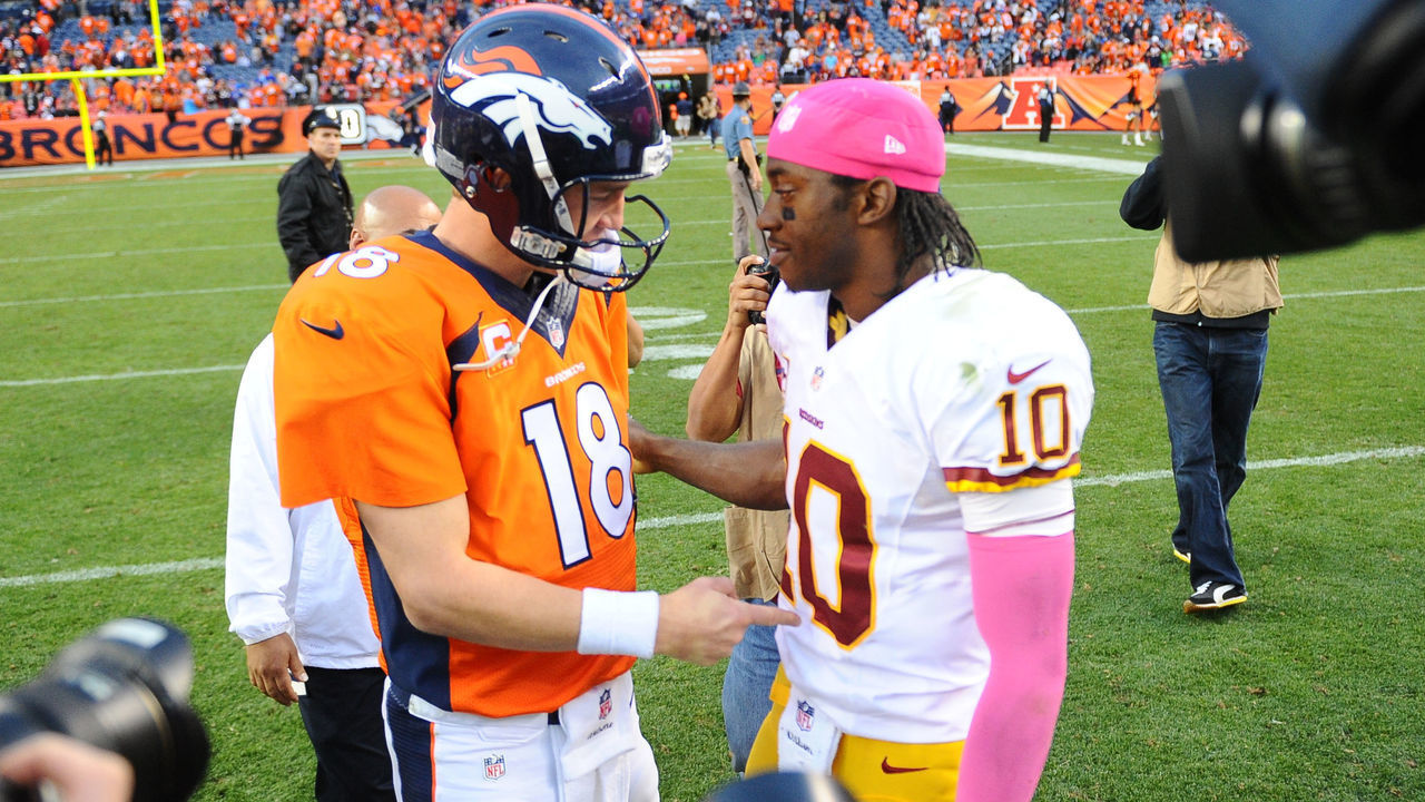 Denver,CO - October 27: Denver Broncos quarterback Peyton Manning (18) greets Washington Redskins quarterback Robert Griffin III (10) following the game on October 27, 2013 in Denver, CO.