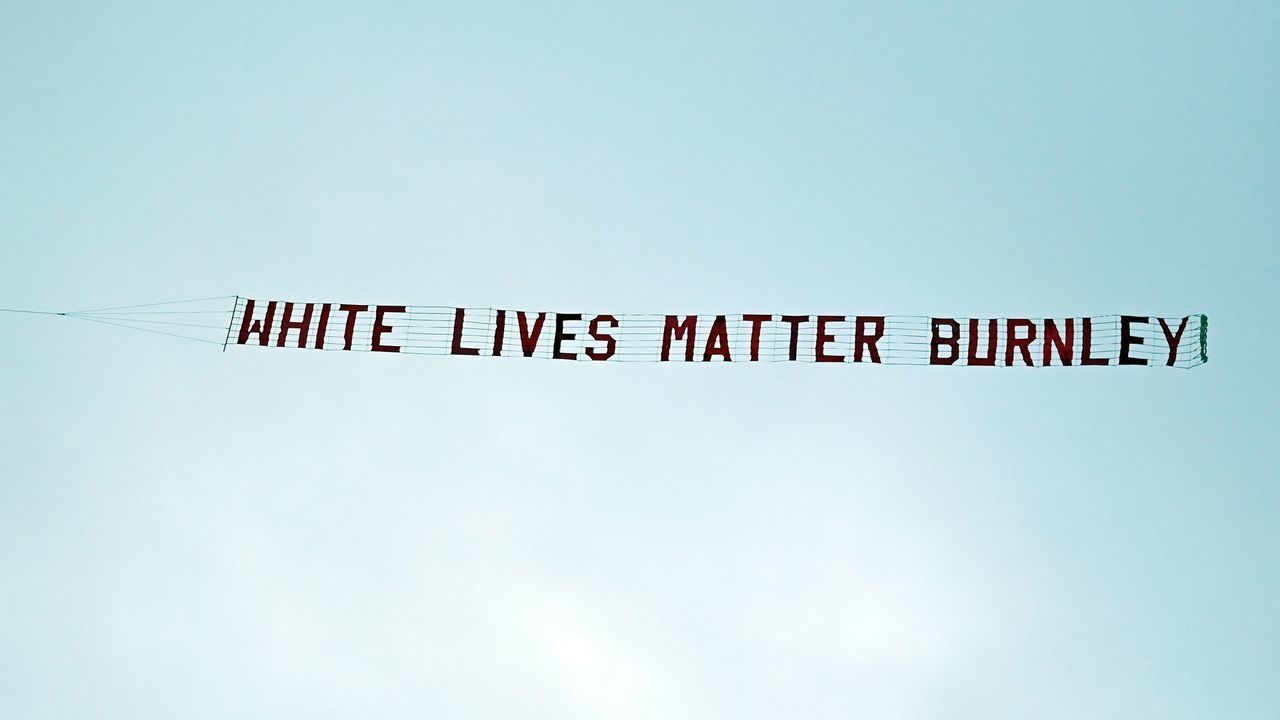 TOPSHOT - A banner reading 'White Lives Matter Burnley' is towed by a plane above the stadium during the English Premier League football match between Manchester City and Burnley at the Etihad Stadium in Manchester, north west England, on June 22, 2020.