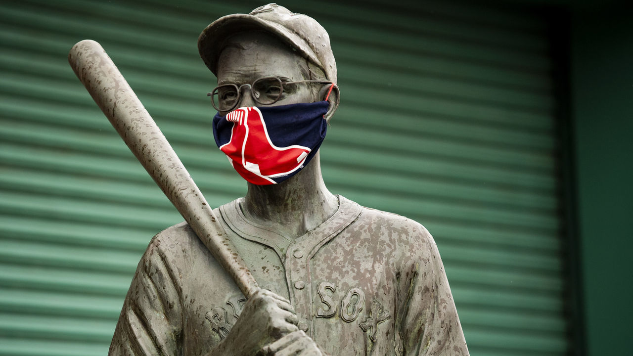 BOSTON, MA - APRIL 9: The "Teammates" statues of former Boston Red Sox players Ted Williams, Bobby Doerr, Johnny Pesky and Dom DiMaggio wear makeshift masks made of Red Sox merchandise as the Major League Baseball season is postponed due the coronavirus pandemic on April 9, 2020 at Fenway Park in Boston, Massachusetts.