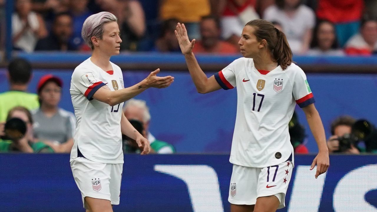 United States' forward Megan Rapinoe (C) celebrates with United States' forward Alex Morgan (L) and United States' forward Tobin Heath (Rafter scoring a goal during the France 2019 Women's World Cup quarter-final football match between France and USA, on June 28, 2019, at the Parc des Princes stadium in Paris.