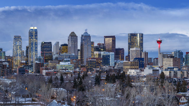 Calgary skyline at dusk. Bow Tower, Calgary, Canada. Architect: Foster + Partners, 2012.. (Photo by: doublespace/View Pictures/Universal Images Group via Getty Images)