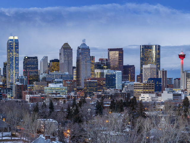 Calgary skyline at dusk. Bow Tower, Calgary, Canada. Architect: Foster + Partners, 2012.. (Photo by: doublespace/View Pictures/Universal Images Group via Getty Images)