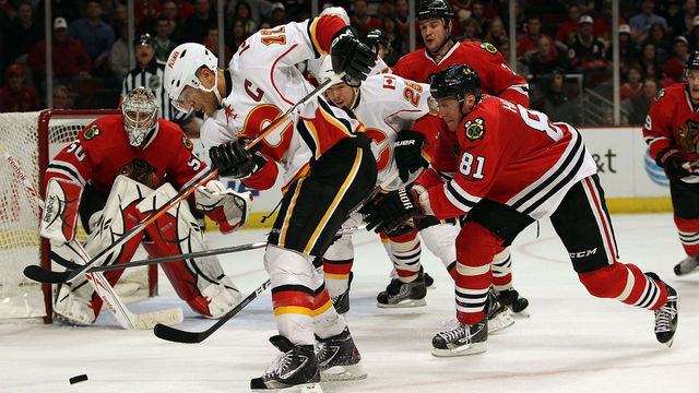 CHICAGO, IL - MARCH 02: Jarome Iginla #12 of the Calgary Flames tries to get off a shot under pressure from Marian Hossa #81 of the Chicago Blackhawks at the United Center on March 2, 2011 in Chicago, Illinois. The Blackhawks defeated the Flames 6-4.
