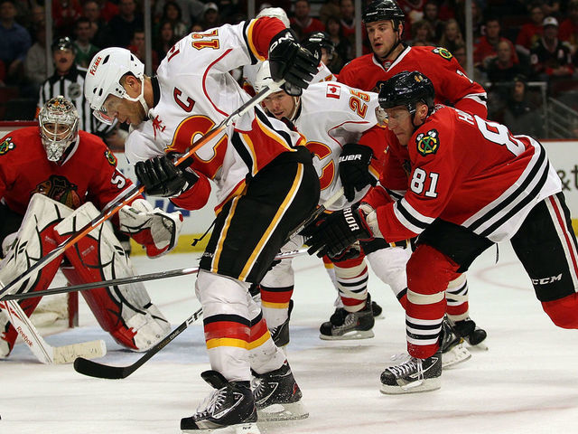 CHICAGO, IL - MARCH 02: Jarome Iginla #12 of the Calgary Flames tries to get off a shot under pressure from Marian Hossa #81 of the Chicago Blackhawks at the United Center on March 2, 2011 in Chicago, Illinois. The Blackhawks defeated the Flames 6-4.