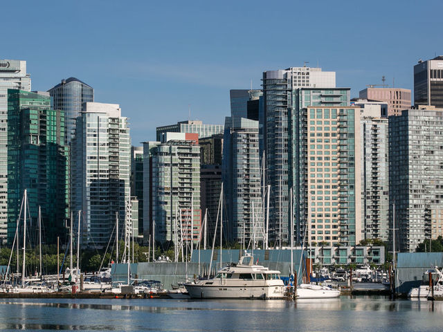 VANCOUVER, CANADA - JUNE 30: The city skyline and Coal Harbour are viewed from Stanley Park on June 30, 2016, in Vancouver, British Columbia, Canada. Vancouver, the largest city in British Columbia, is the most populous city in Western Canada and was the site of the 2010 Winter Olympic Games.