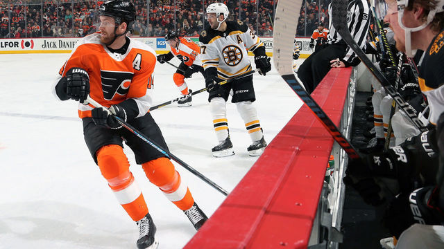 PHILADELPHIA, PA - JANUARY 13: Sean Couturier #14 and Matt Niskanen #15 of the Philadelphia Flyers skate along the bench against Patrice Bergeron #37 of the Boston Bruins on January 13, 2020 at the Wells Fargo Center in Philadelphia, Pennsylvania.