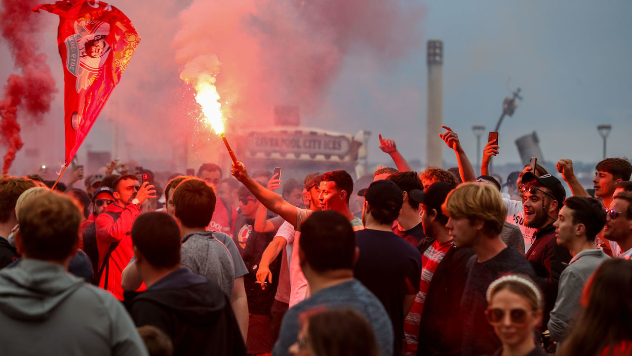 Liverpool fans let off flares outside the Liver Building in Liverpool.