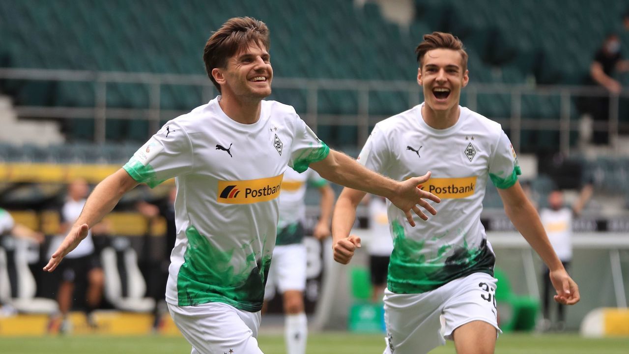 Borussia Moenchengladbach's Jonas Hofmann (L) celebrates scoring their first goal during the German first division Bundesliga football match between Borussia Moenchengladbach vs Hertha Berlin's, in Moenchengladbach, western Germany, on June 27, 2020.