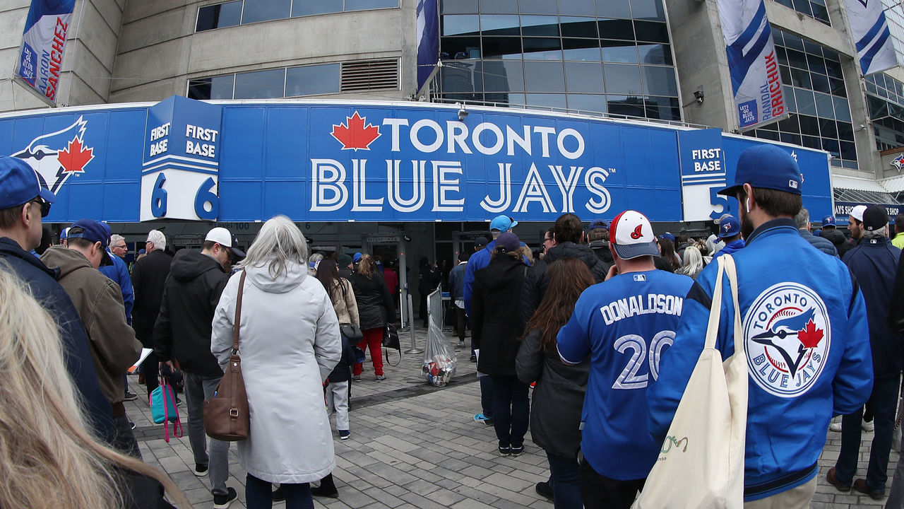 TORONTO, ON - MARCH 28: Fans gather outside the Rogers Centre on Opening Day before the Toronto Blue Jays MLB game against the Detroit Tigers at Rogers Centre on March 28, 2019 in Toronto, Canada.