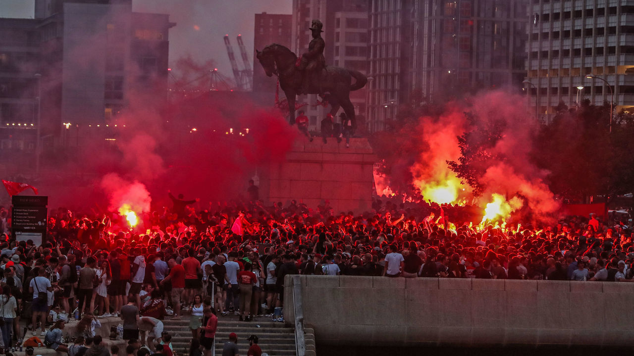 Liverpool fans let off flares outside the Liver Building in Liverpool.