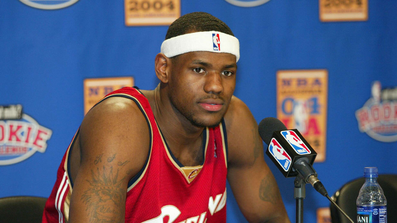 LOS ANGELES - FEBRUARY 13: LeBron James #23 of the rookie team speaks during a news conference before the Got Milk? Rookie Challenge game, part of the 53rd NBA All-Star weekend at Staples Center February 13, 2004 in Los Angeles, California. NOTE TO USER: User expressly acknowledges and agrees that, by downloading and/or using this Photograph, User is consenting to the terms and conditions of the Getty Images License Agreement.