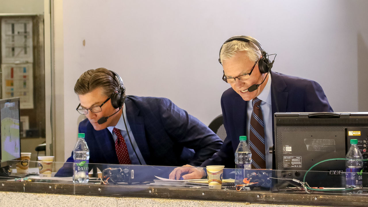 WINNIPEG, MB - MARCH 16: Hockey Night in Canada broadcasters Craig Simpson (L) and Jim Hughson look on as they call second period action between the Winnipeg Jets and the Calgary Flames at the Bell MTS Place on March 16, 2019 in Winnipeg, Manitoba, Canada. The Jets defeated the Flames 2-1.
