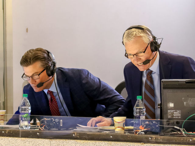 WINNIPEG, MB - MARCH 16: Hockey Night in Canada broadcasters Craig Simpson (L) and Jim Hughson look on as they call second period action between the Winnipeg Jets and the Calgary Flames at the Bell MTS Place on March 16, 2019 in Winnipeg, Manitoba, Canada. The Jets defeated the Flames 2-1.