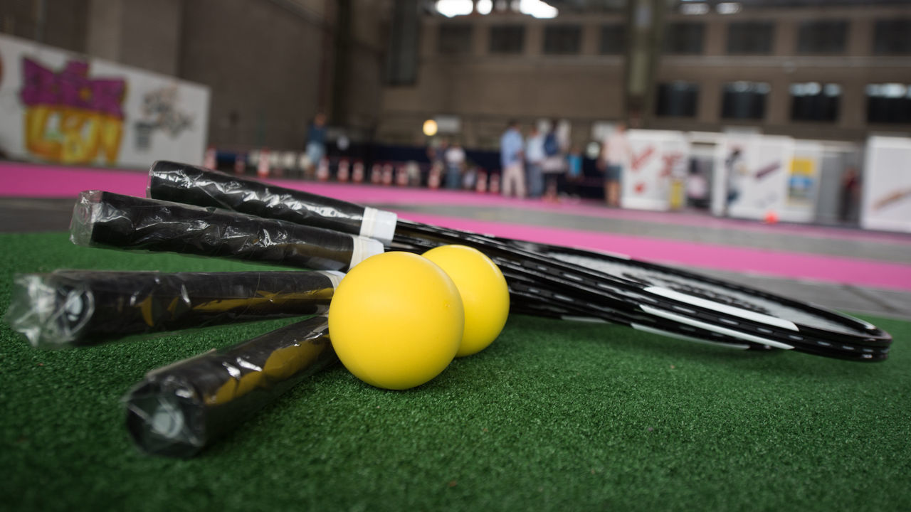 Tennis racquets lie on the ground in an emergency accommodation for refugees at the former Tempelhof Airport in Berlin, Germany, 27 July 2016. An indoor sports hall was opened today in Hangar 1. Photo: JANNIS MATTAR/dpa | usage worldwide