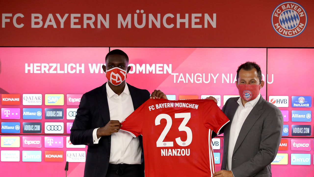 MUNICH, GERMANY - JULY 01: FC Bayern Muenchen sport director Hasan Salihamidzic (R) and newly signed FC Bayern Muenchen player Tanguy Kouassi (L) present a jersey with the new squad number during a press conference at Saebener Strasse training ground on July 01, 2020 in Munich, Germany.