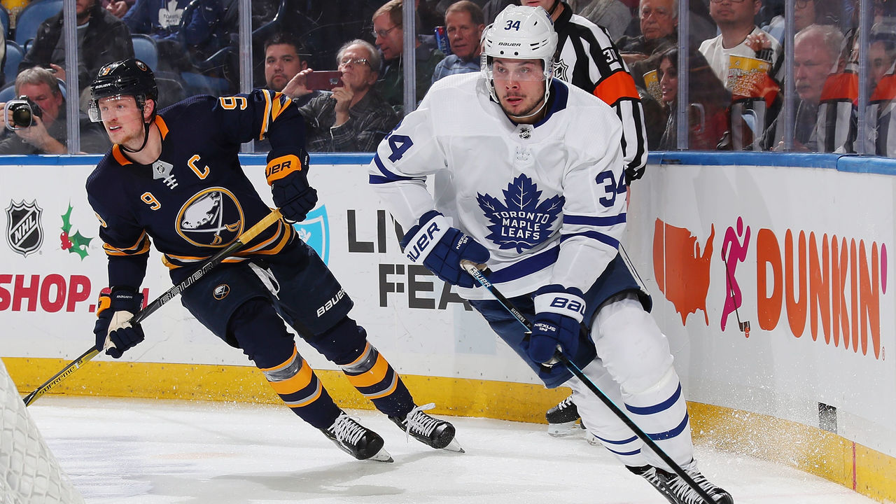 BUFFALO, NY - DECEMBER 4: Auston Matthews #34 of the Toronto Maple Leafs controls the puck against Jack Eichel #9 of the Buffalo Sabres during an NHL game on December 4, 2018 at KeyBank Center in Buffalo, New York.