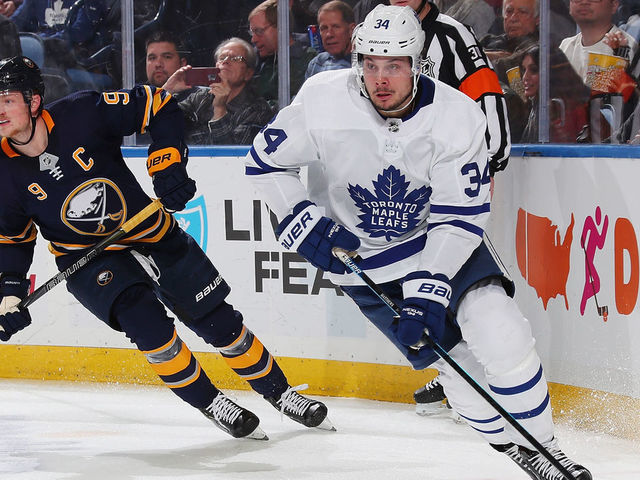 BUFFALO, NY - DECEMBER 4: Auston Matthews #34 of the Toronto Maple Leafs controls the puck against Jack Eichel #9 of the Buffalo Sabres during an NHL game on December 4, 2018 at KeyBank Center in Buffalo, New York.