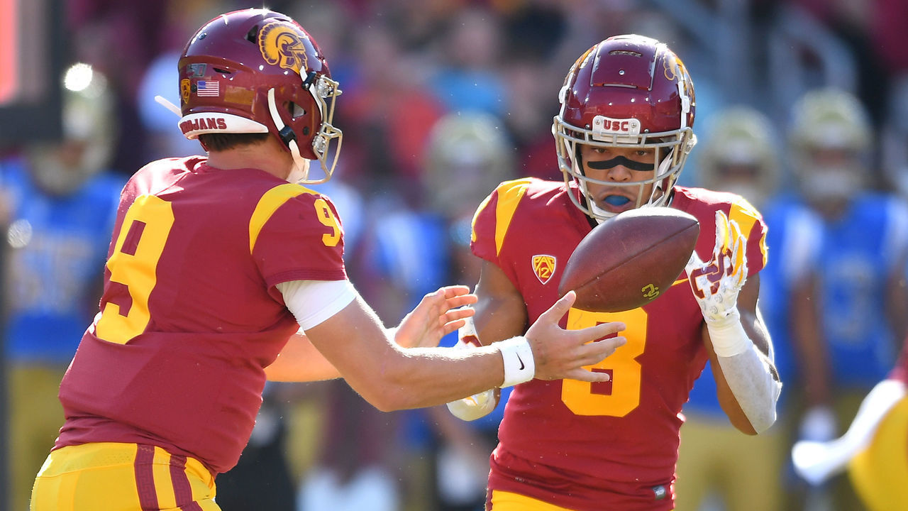 LOS ANGELES, CA - NOVEMBER 23: Quarterback Kedon Slovis #9 hands off the ball to wide receiver Amon-Ra St. Brown #8 of the USC Trojans in the first half of the game against the UCLA Bruins at the Los Angeles Memorial Coliseum on November 23, 2019 in Los Angeles, California.