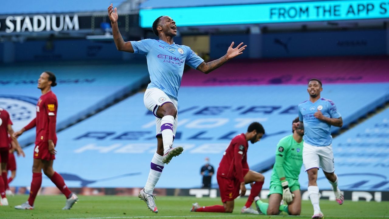 Manchester City's English midfielder Raheem Sterling (C) jumps to celebrates scoring his team's second goal during the English Premier League football match between Manchester City and Liverpool at the Etihad Stadium in Manchester, north west England, on July 2, 2020.