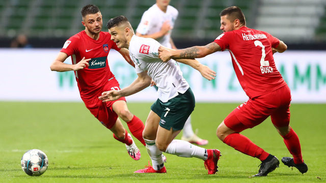 BREMEN, GERMANY - JULY 02: Milot Rashica of Bremen is challenged by Marnon Busch of Heidenheim during the Bundesliga playoff first leg match between Werder Bremen and 1. FC Heidenheim at Wohninvest Weserstadion on July 02, 2020 in Bremen, Germany.