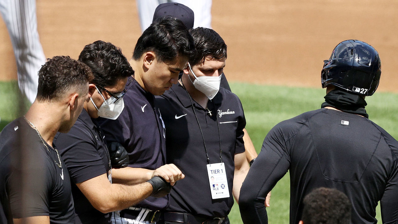 NEW YORK, NEW YORK - JULY 04: Masahiro Tanaka #19 of the New York Yankees is helped off the field after he was hit in the head by a batted ball during summer workouts at Yankee Stadium on July 04, 2020 in the Bronx borough of New York City.