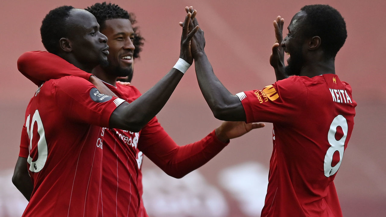 Liverpool's Senegalese striker Sadio Mane (L) celebrates scoring his team's first goal during the English Premier League football match between Liverpool and Aston Villa at Anfield in Liverpool, north west England on July 5, 2020.