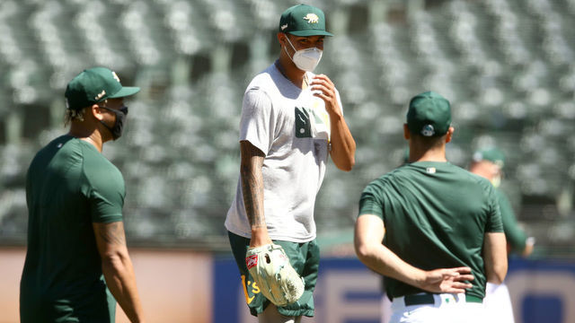 OAKLAND, CALIFORNIA - JULY 05: Sean Manaea #55 of the Oakland Athletics talks with other pitchers during summer workouts at RingCentral Coliseum on July 05, 2020 in Oakland, California.