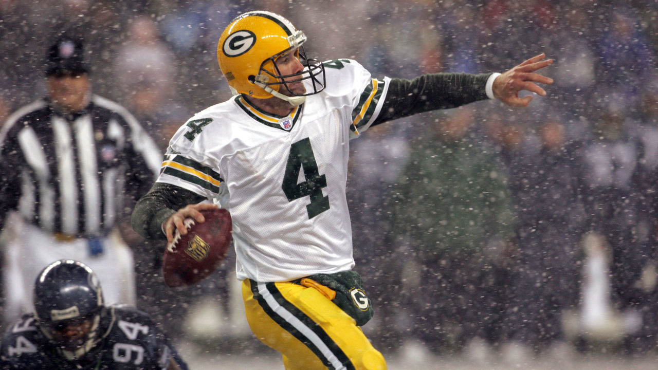 Green Bay quarterback Brett Favre throws downfield as he runs out of the backfield away from Seahawks Bryce Fisher during the first half of the NFL game on Monday Night Football November 27, 2006 at Qwest Field in Seattle, Washington.