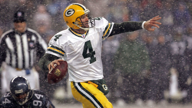 Green Bay quarterback Brett Favre throws downfield as he runs out of the backfield away from Seahawks Bryce Fisher during the first half of the NFL game on Monday Night Football November 27, 2006 at Qwest Field in Seattle, Washington.
