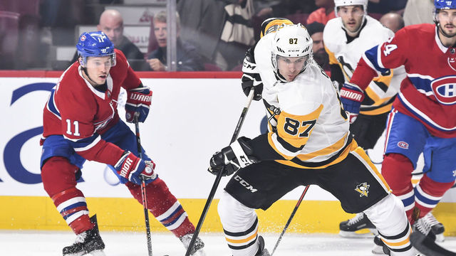 MONTREAL, QC - OCTOBER 13: Sidney Crosby #87 of the Pittsburgh Penguins skates the puck against Brendan Gallagher #11 of the Montreal Canadiens during the NHL game at the Bell Centre on October 13, 2018 in Montreal, Quebec, Canada.