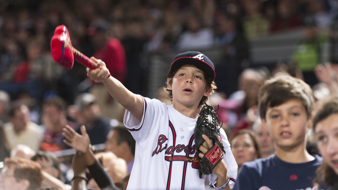 ATLANTA, GA - SEPTEMBER 28: A fan does the Tomahawk Chop during the game against the Philadelphia Phillies at Turner Field on September 28, 2013 in Atlanta, Georgia. The Phillies won 5-4.