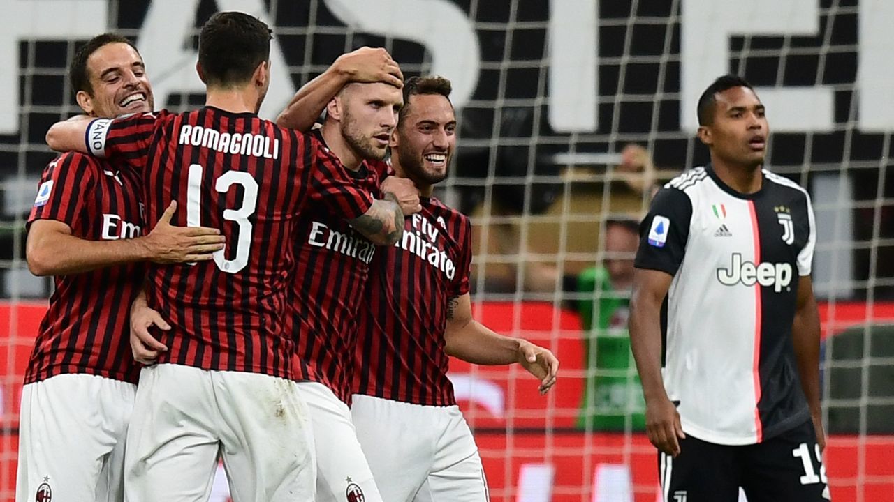 AC Milan's Croatian forward Ante Rebic (C) celebrates with teammates after scoring Milan's 4th goal, during the Italian Serie A football match AC Milan vs Juventus played behind closed doors on July 7, 2020 at the San Siro stadium in Milan, as the country eases its lockdown aimed at curbing the spread of the COVID-19 infection, caused by the novel coronavirus.