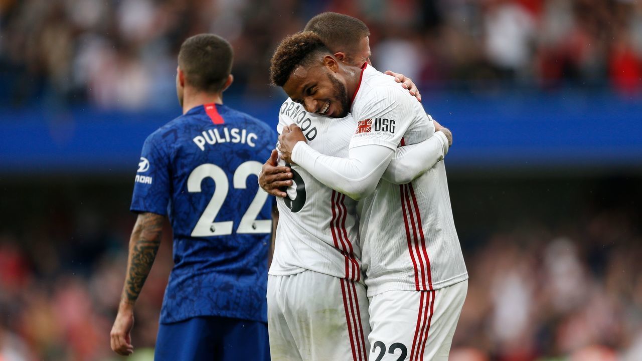Sheffield United's French striker Lys Mousset (R) embraces Sheffield United's English-born Northern Irish midfielder Oliver Norwood (L) after the final whistle in the English Premier League football match between Chelsea and Sheffield United at Stamford Bridge in London on August 31, 2019.