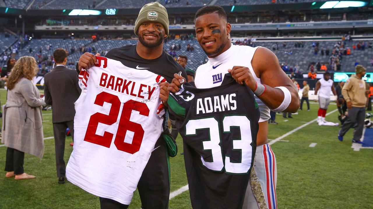 EAST RUTHERFORD, NJ - NOVEMBER 10: New York Jets strong safety Jamal Adams (33) and New York Giants running back Saquon Barkley (26) swap jerseys after the National Football League game between the New York Jets and the New York Giants on November 10, 2019 at MetLife Stadium in East Rutherford, NJ.