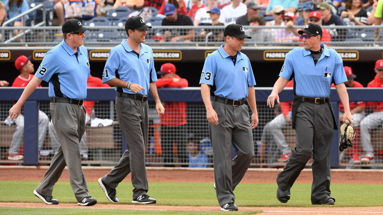 PEORIA, ARIZONA - MARCH 10: Home plate umpire Quinn Wolcott #81 and umpires Tripp Gibson #73, Pat Hoberg #31 and Chad Whitson #62 walk to home plate prior to the start of a spring training game between the Seattle Mariners and the Los Angeles Angels at Peoria Stadium on March 10, 2020 in Peoria, Arizona.