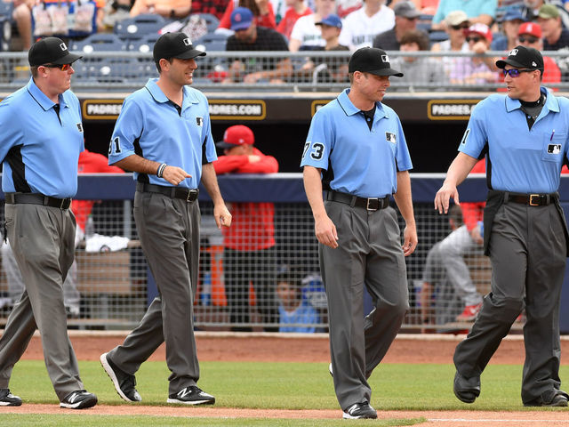 PEORIA, ARIZONA - MARCH 10: Home plate umpire Quinn Wolcott #81 and umpires Tripp Gibson #73, Pat Hoberg #31 and Chad Whitson #62 walk to home plate prior to the start of a spring training game between the Seattle Mariners and the Los Angeles Angels at Peoria Stadium on March 10, 2020 in Peoria, Arizona.
