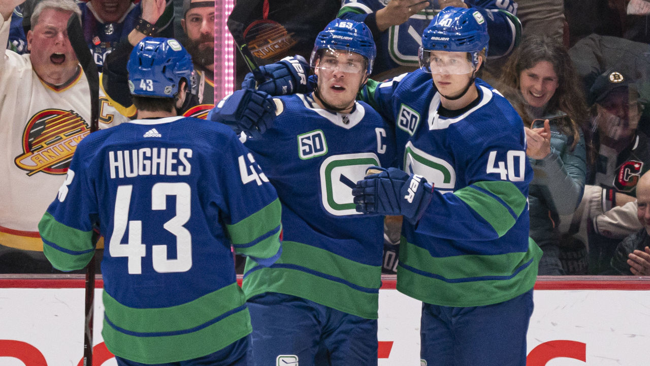 VANCOUVER, BC - FEBRUARY 22: Bo Horvat #53 of the Vancouver Canucks celebrates with Quinn Hughes #43 and Elias Pettersson #40 after scoring a goal against the Boston Bruins during NHL action at Rogers Arena on February 22, 2020 in Vancouver, Canada.