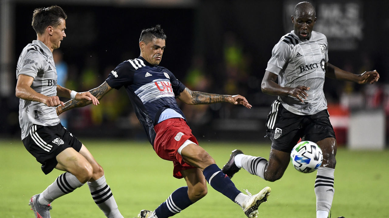 REUNION, FLORIDA - JULY 09: Gustavo Bou #7 of New England Revolution looks to kick the ball during the first half against the Montreal Impact in the MLS is Back Tournament at ESPN Wide World of Sports Complex on July 09, 2020 in Reunion, Florida.